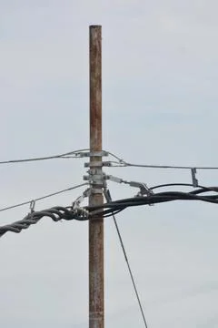 Rusted utility pole with electrical cables Stock Photos