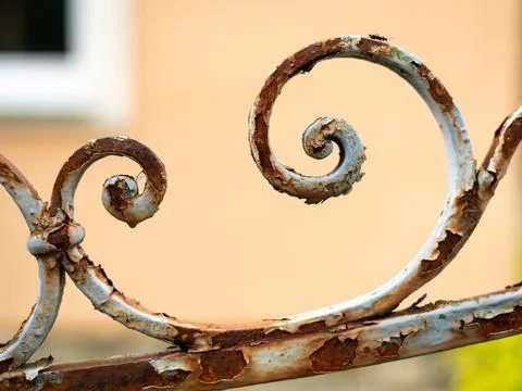 Rusted wrought iron decorative scroll railing with flaking white paint deta.. Stock Photos