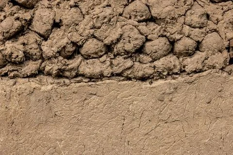 Rustic adobe wall texture partially plastered with same material Stock Photos