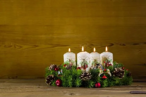 Rustic  advent wreath or crown with four burning white candles. Stock Photos