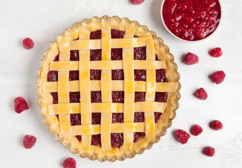 Rustic american raspberry pie preparation with jam and raspberries on white Stock Photos