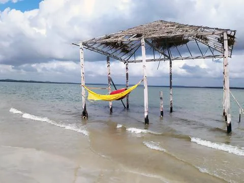 Rustic and old tent with hammock inside the beach. Deserted beach of Mangue S Stock Photos