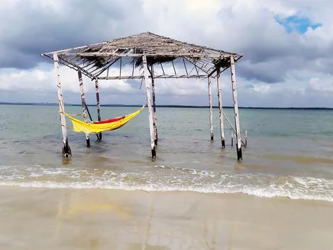 Rustic and old tent with hammock inside the beach. Deserted beach of Mangue S Stock Photos