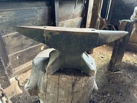 Rustic anvil in a wood workshop Stock Photos