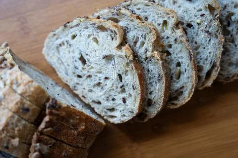 Rustic artisan bread cut in half on board Stock Photos