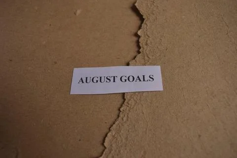 Rustic August Goals message on handcrafted paper with natural textured back.. Fotos Stock