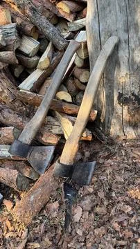Rustic Axes and Firewood Stack in Golden Sunlight Stock Photos