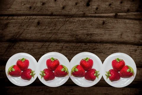 Rustic background with decorative border of strawberries Stock Photos