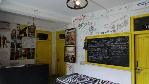 Rustic Backpacker Hostel Reception Featuring Colorful Doors, Graffiti, and .. Stock Footage 344655842