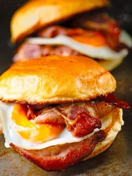 Rustic bacon egg breakfast sandwich bun Stock Photos