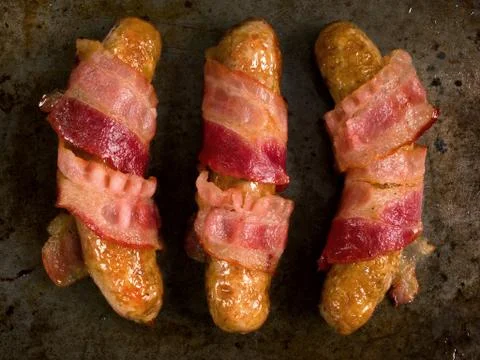 Rustic bacon wrapped sausage Stock Photos