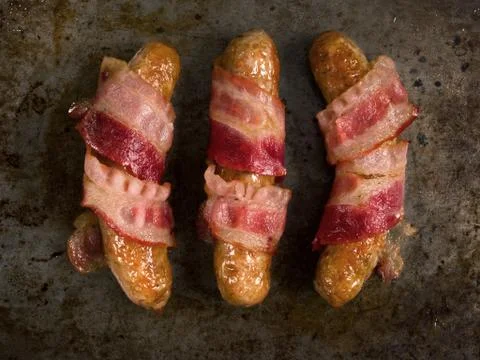 Rustic bacon wrapped sausage Stock Photos