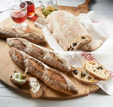 Rustic baguettes and olive bread Stock Photos