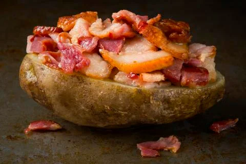 Rustic baked jacket potato with bacon Stock Photos