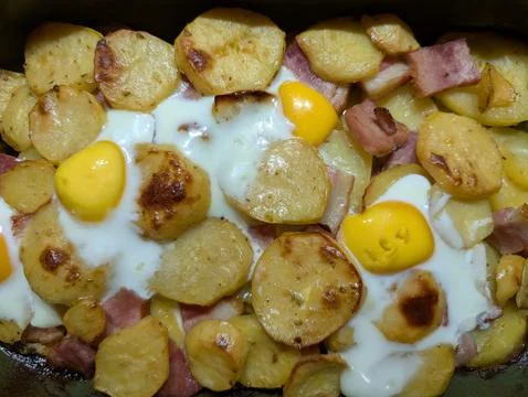 Rustic Baked Potatoes, Bacon, Eggs Skillet Meal Stock Photos