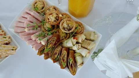 Rustic bakery selection featuring savory pies, ham cheese rolls, vegetable wraps Stock Photos