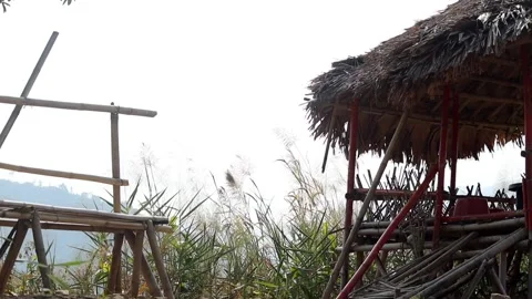 Rustic Bamboo Seating Area with Thatched Shelter Stock Footage 329839474