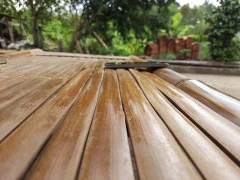 Rustic bamboo surface provides a natural setting for a modern smartphone device Stock Photos