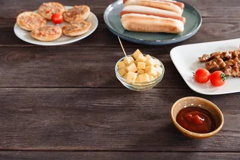 Rustic Bar Snacks With Cheese, Hot Dogs, And Dips Stock Photos