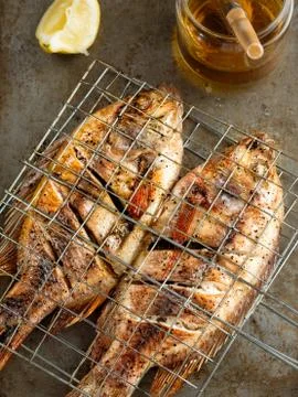 Rustic barbecued grilled fish Stock Photos