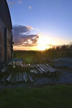  Rustic Barn And Stacked Lumber At Sunset Stock Photos