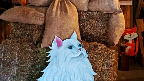 Rustic barn display with stacked hay bales and burlap sacks, featuring a cute Stock Footage 333323864