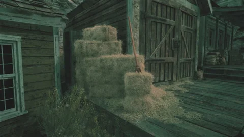 A rustic barn with hay bales in the foreground Stock-Footage 251899695