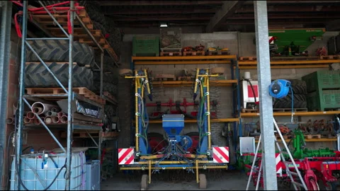 Rustic Barn Storage with Tractor Trailer and Farming Equipment Stock Footage 305186783