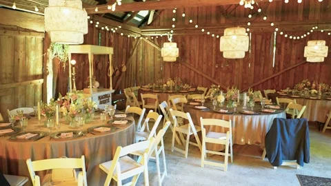 Rustic Barn Wedding Reception Decorated with String Lights and Elegant Floral Stock Footage 338404281