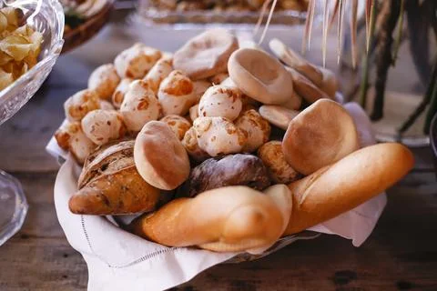 Rustic basket with assorted breads and fresh cheese bread Stock Photos