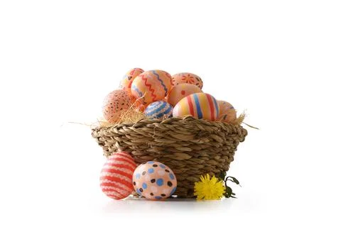 Rustic Basket with Bright Easter Eggs Stock Photos