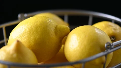 A rustic basket filled with ripe yellow lemons Stock Footage 308462145