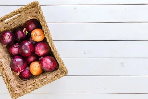 Rustic basket with a mix of red and brown onions Stock Photos