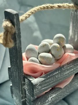 Rustic Basket with Pastel Easter Eggs Stock Photos