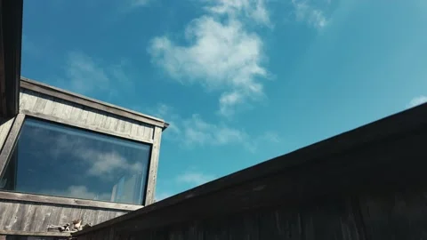 Rustic beach house with clouds moving over building Stock Footage 279785141