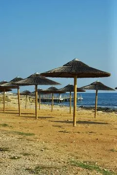 Rustic Beach Umbrellas Facing Ayia Napa Pier Stock Photos