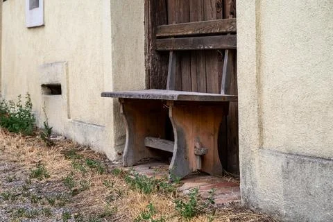 Rustic bench by the door. Stock Photos