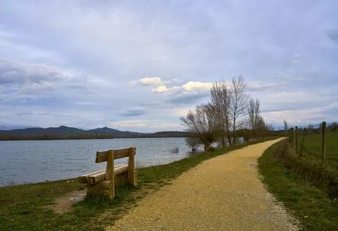 Rustic bench to rest from the walk by the lake Photos