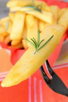 Rustic big potatoes slice fried with rosemary aroma Stock Photos