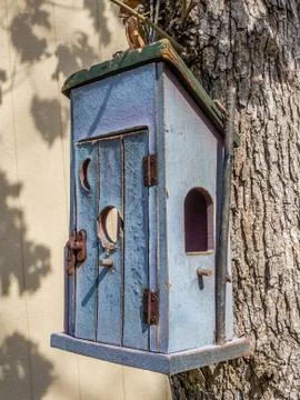 Rustic bird house hanging on the tree Stock Photos