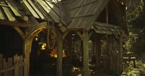 Rustic blacksmith shop surrounded by forest during golden hour Stock Footage 321779386