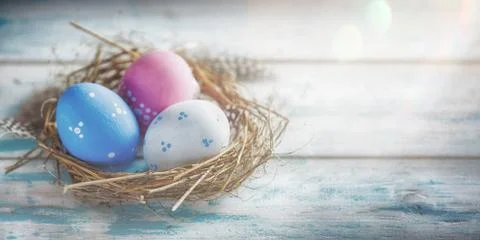 Rustic Blue, Red and White Egg in the Hay Nest Stock Photos