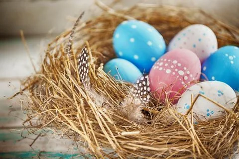 Rustic Blue, Red and White Egg in the Hay Nest Stock Photos