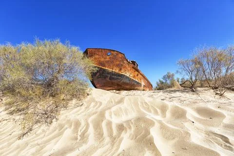 Rustic boat on a ship graveyard on a desert around Moynaq, Aral sea, Uzbekist Photos