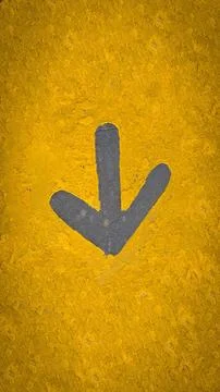 Rustic bold grey down arrow sign on a vibrant yellow, textured wall. Ideal .. Stock Photos