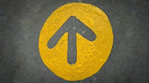 Rustic bold yellow arrow points upward inside a circle, stamped on rough da.. Stock Photos
