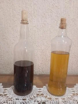 "Rustic bottles with liquids on decorated table" Stock Photos