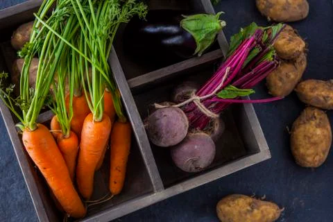 Rustic box with fresh carrots, beetroot, aubergine and potatoes 写真素材