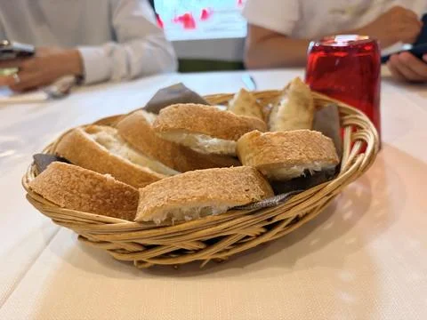 Rustic Bread Basket in Cozy Restaurant Setting Stock Photos