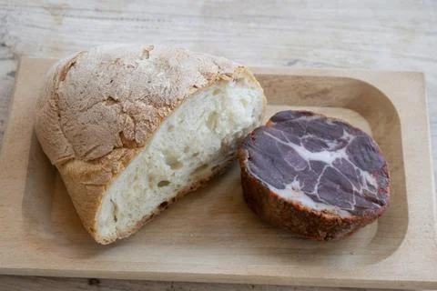 Rustic bread cured meat capocollo wooden board Stock Photos